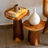 Two wooden side tables with decorative items on a tiled floor.