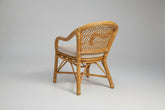 Wicker chair with white cushion on a white background