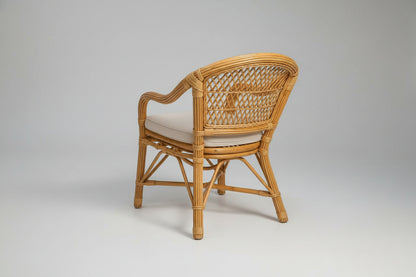 Wicker chair with white cushion on a white background