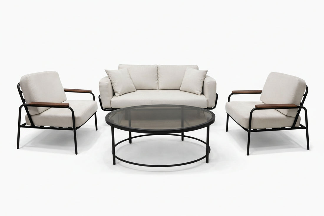 Outdoor furniture set with a sofa, two chairs, and a round table on a white background